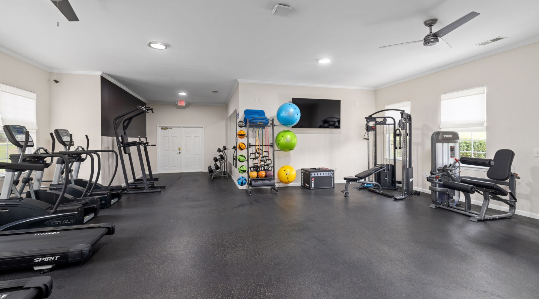 a gym with exercise equipment and tv