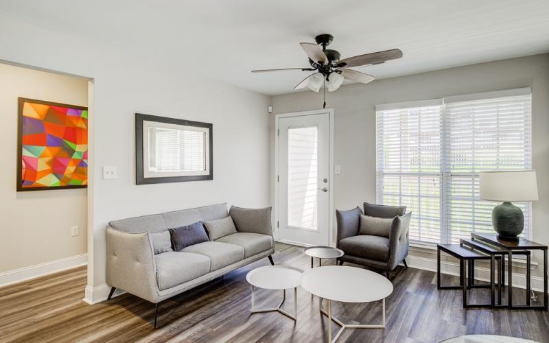 a living room with a couch and a fan