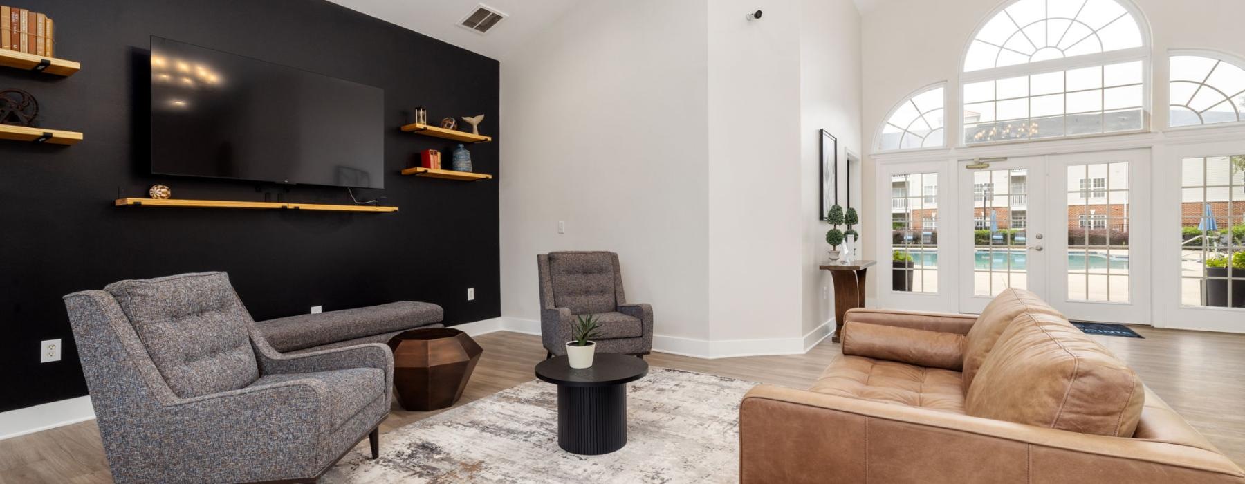 a lounge with a large tv and seating