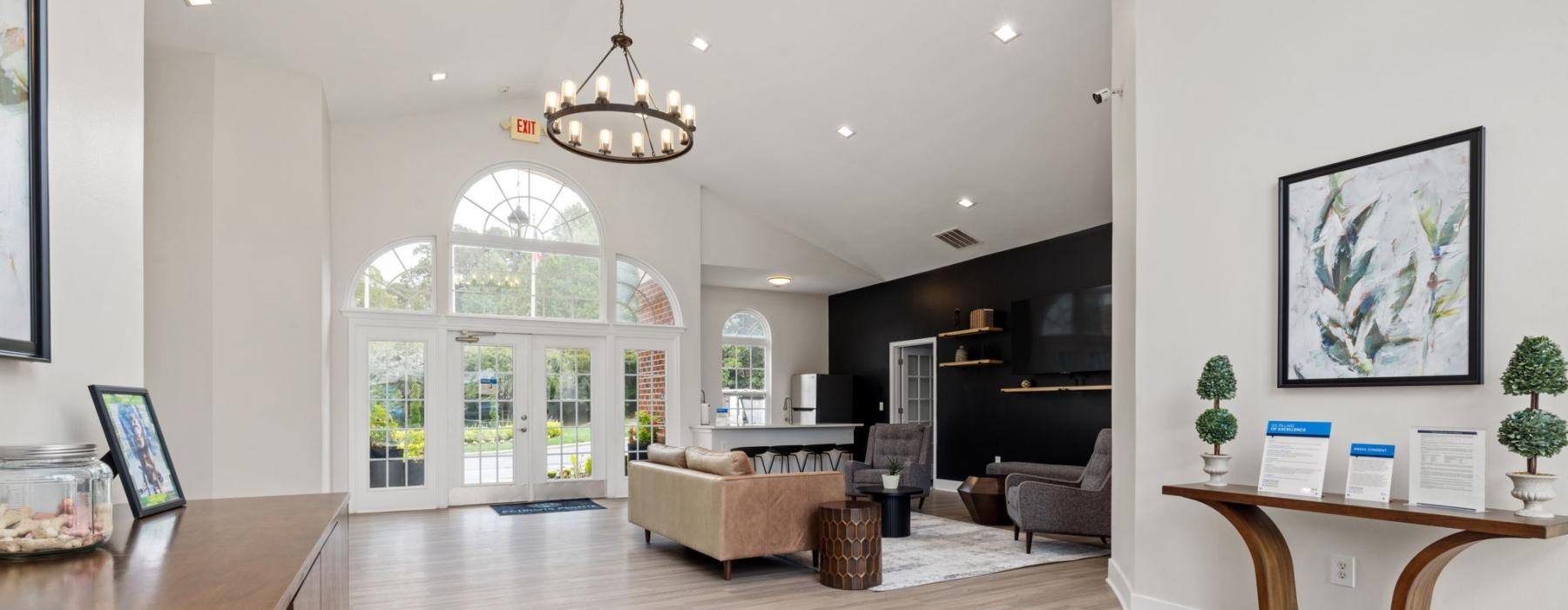 a large room with a large chandelier and a couch