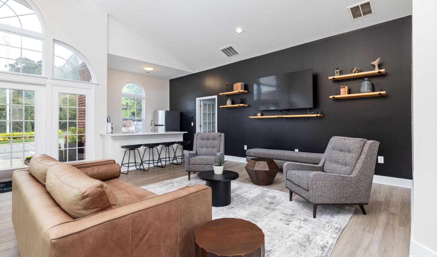 a lounge with a tv and seating