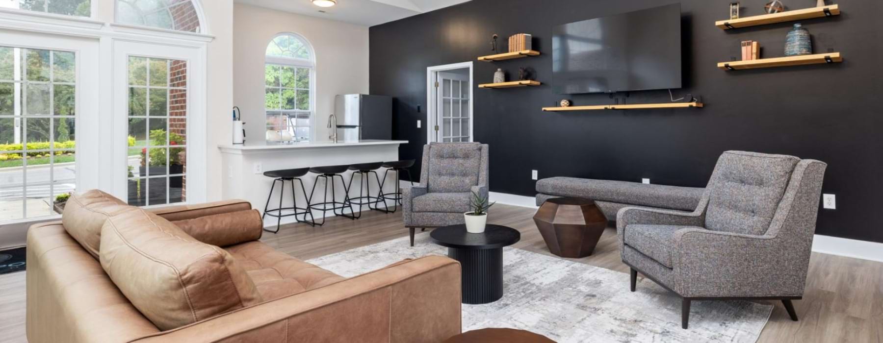 a lounge with a tv and seating